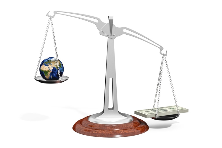 Scale weighing globe and heavier cash pile
