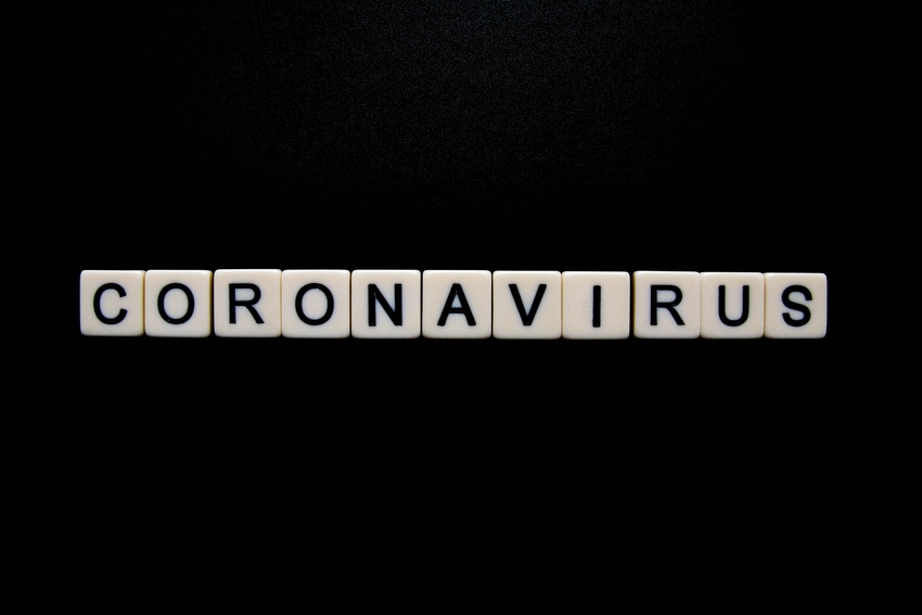 Coronavirus spelled out in tile letters against a black background