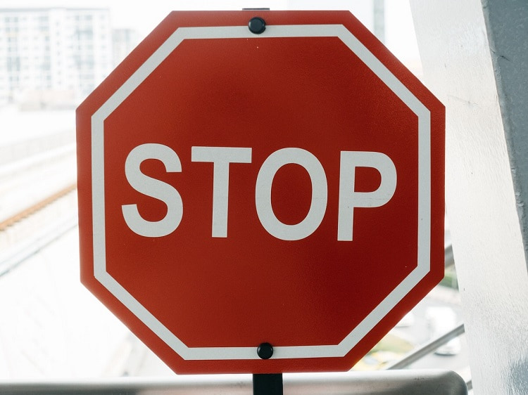 Stop sign in sunlight on city block