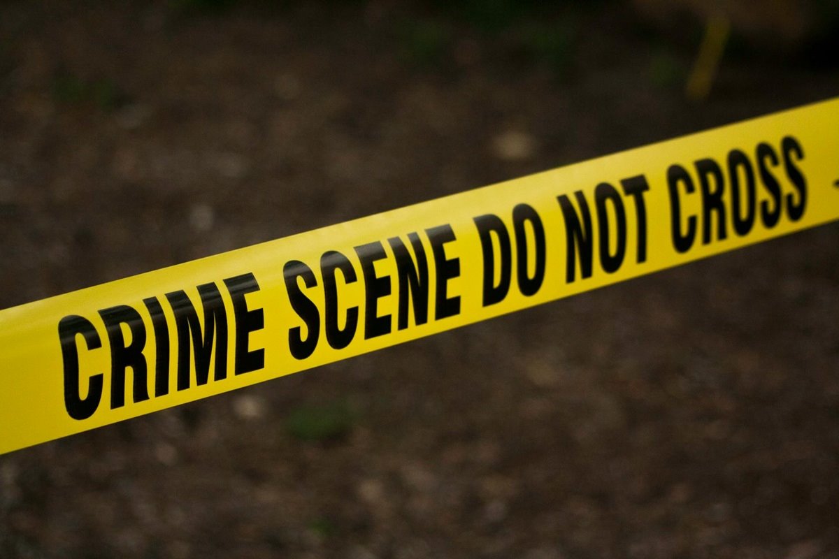 Yellow police tape labelled 'crime scene do not cross'