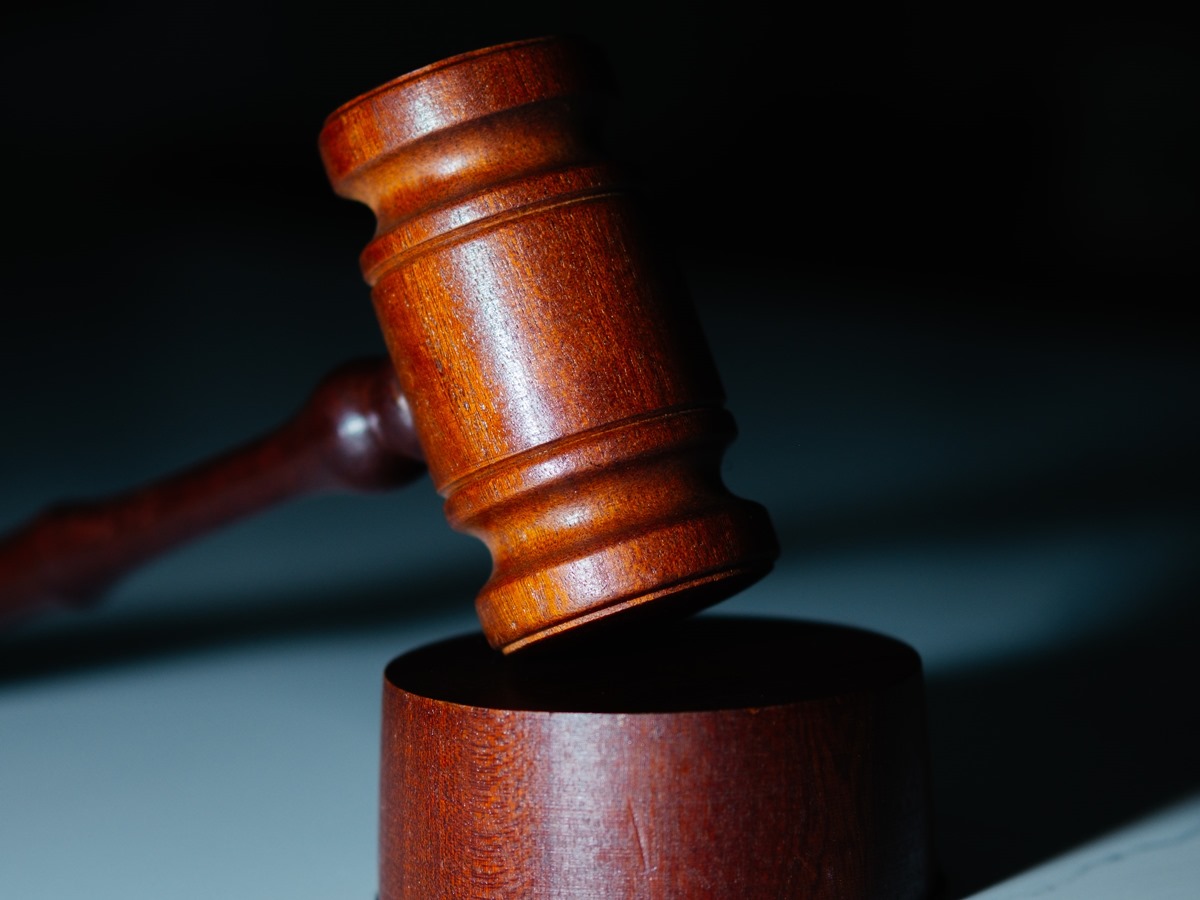 Mahogany wood gavel and stopper on white tabletop